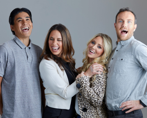 4 people staring at camera and laughing